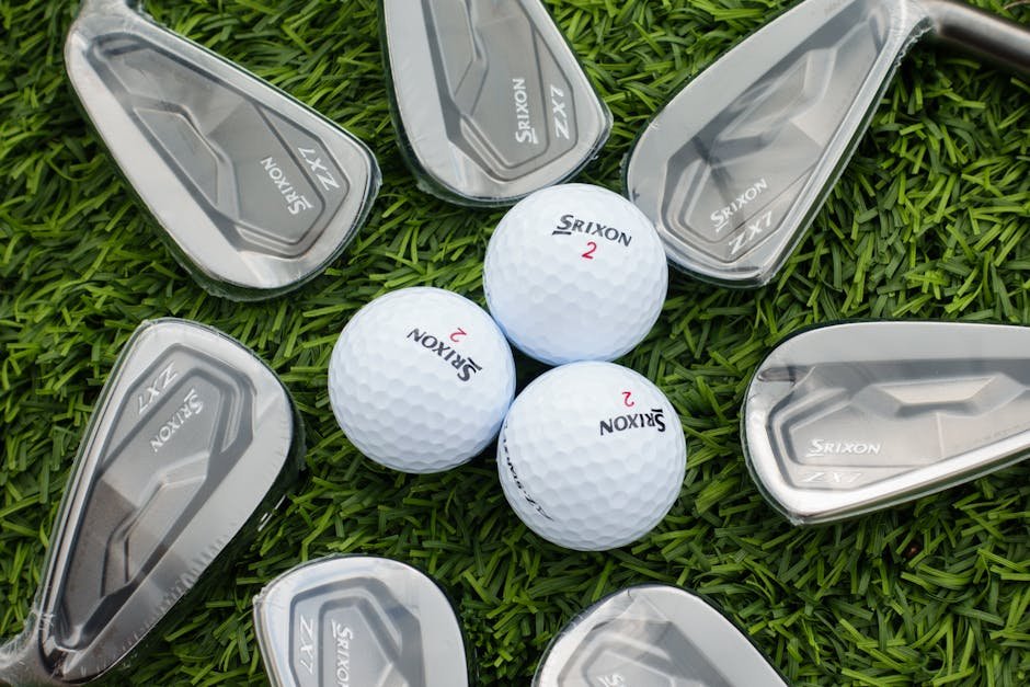 Top view of Srixon golf clubs and balls arranged on lush green grass, showcasing premium sports equipment.